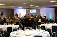 People preparing for a banqueting style meeting
