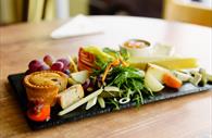 Platter with pork pie, fruit, crackers, cheese