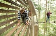 Crawling through the wooden tunnel
